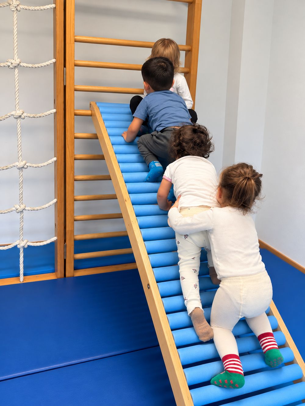 Kind klettert an einem Spielgerät